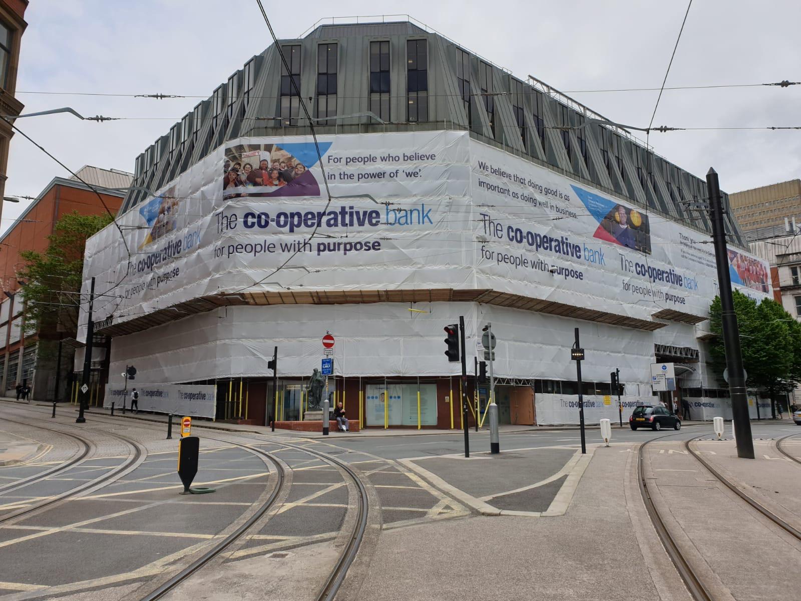 Co-operative Bank printed scaffold wrap on a city-centre corner building
